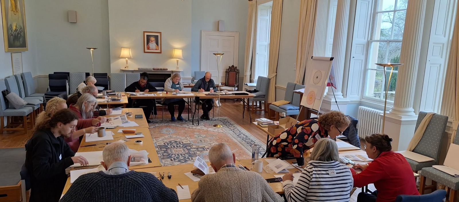 Students gathered around tables studying geometric figures during a retreat session